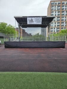 A stage with black tarps on the side of it.