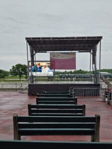 A stage with benches and chairs in front of it