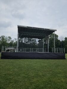 A stage with black tarp covering the top of it.