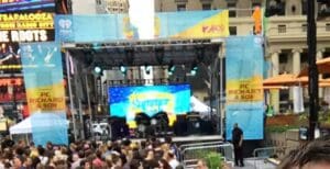 A crowd of people sitting on top of stage.