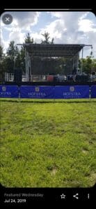 A field with grass and blue banners on it.